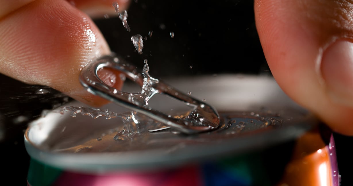 Fingers opening beer can